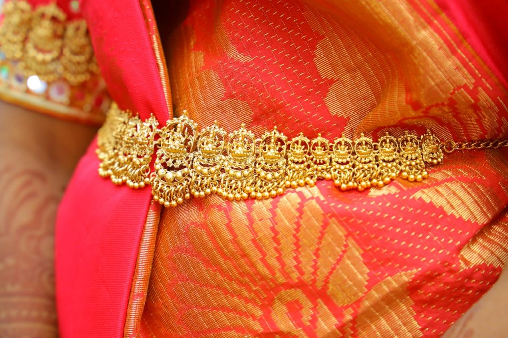 Gold Jewelry over Orange Textile